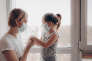 mother and daughter wearing masks