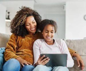 A mother who receives child support sits with her daughter.